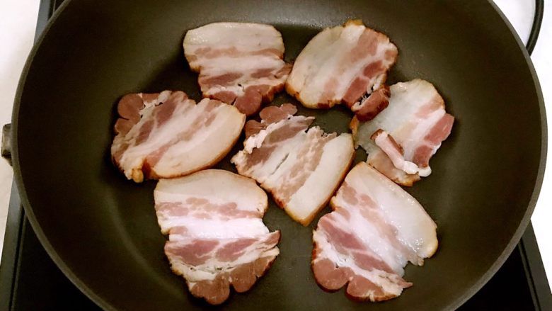 干锅什锦小炒,炒锅烧热后放入腊肉,小火煎制