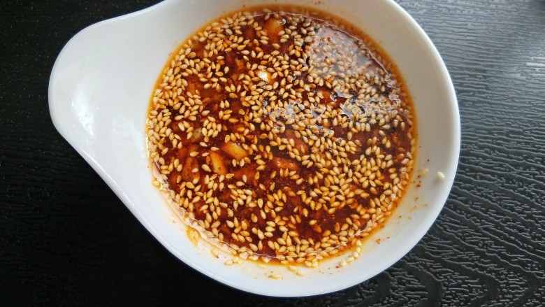 自制饺子蘸料(附辣椒油的制作方法),放两勺辣椒油,搅拌均匀。