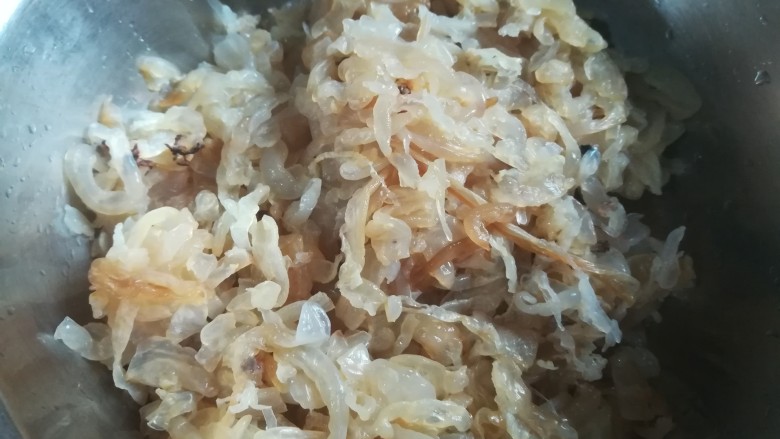 人人都爱吃凉拌海蜇皮,浸泡后,不咸的海蜇皮,用手使劲捏干水分。