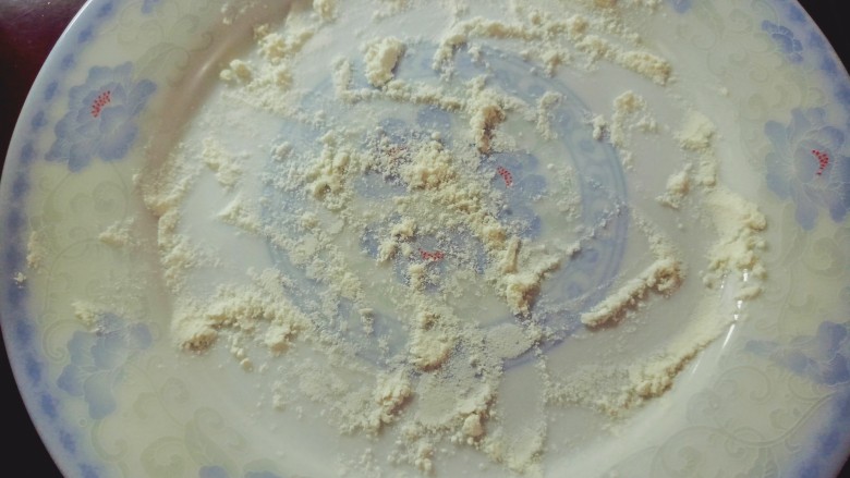 芋泥柿饼,准备一个空盘子,撒上面粉,并另外备些面粉