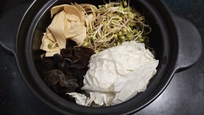 家庭版火锅鸡~快手版,早晨开始做饭:把洗好的菜放入砂锅平铺。