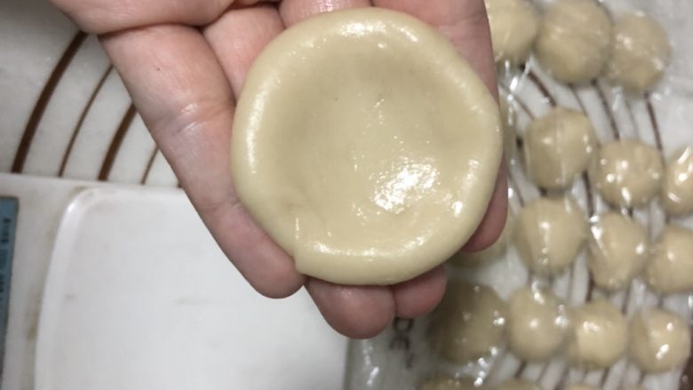 椒盐芝麻牛舌饼,进行包酥,取一个水油皮按扁