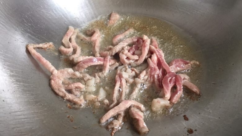 芹菜胡萝卜炒肉丝,锅内放油烧热,放入肉丝翻炒至变色