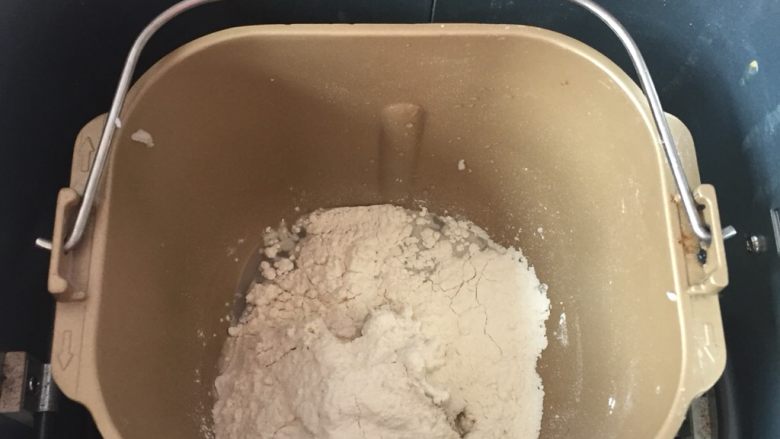 蛋黄酥(猪油版),油皮材料放入面包机内,选择揉面健揉成团。