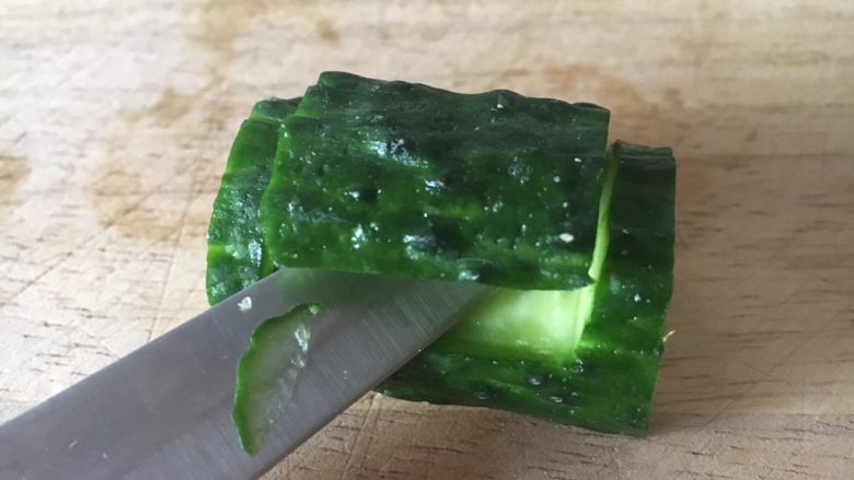 翠竹报春,量黄瓜节的底部削平,便于摆放。在黄瓜节的上面用小刀划一个如图所示的长方形,并且用小刀把这片黄瓜翘起来。