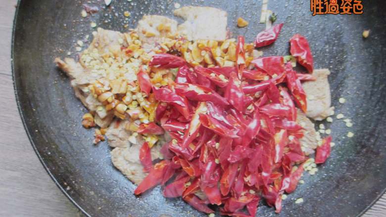 香辣猪肉干,放入剪好的辣椒、花椒、麻椒翻炒均匀,