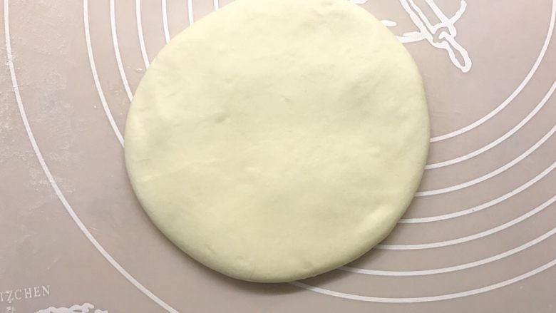 老北京烧饼夹肉,取出醒好的面团,揉捏排气,将面团揉光滑后用手压扁