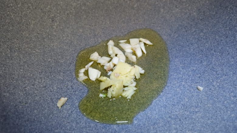 红白豆腐炖肉末, 锅内倒入食用油,烧到八成热,下入姜和蒜在油锅中爆香。