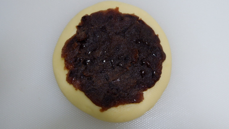 豆沙蛋黄面包,取一个松弛的好面团,擀开,均匀的涂抹上<a style='color:red;display:inline-block;' href='/shicai/ 6517'>豆沙</a>馅