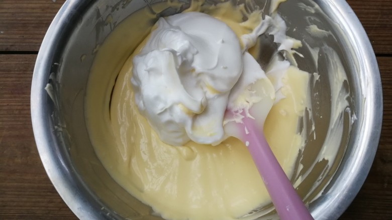 轻乳酪蛋糕,取1/3打发的蛋清入拌好的蛋黄糊中,用刮刀翻拌均匀