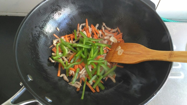 肉炒三丝,青椒丝放入,大火翻炒几下