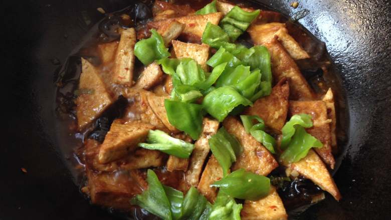 家常豆腐,放入青椒块,中火翻炒半分钟