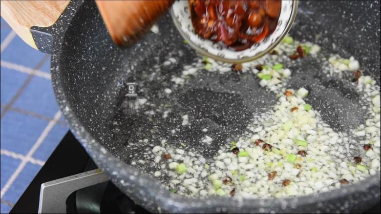 嫩滑爽口,简单又下饭的家常菜肴——麻婆豆腐,热锅冷油后,放入花椒、葱花、姜末、豆瓣酱炒出红油。