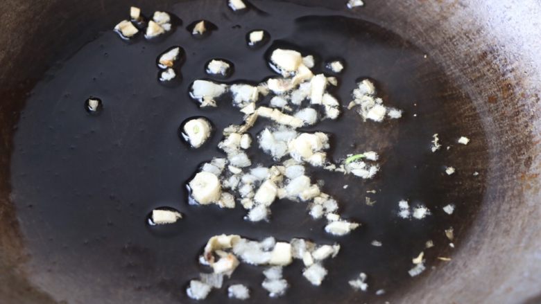 红椒炒鱿鱼,锅内放适量的色拉油,放入蒜末炒香,