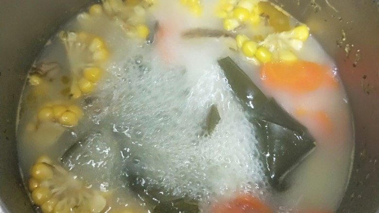 养生玉米海带浓汤,煮沸后转小火,继续煮40分钟,至汤汁浓稠奶白。