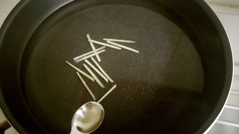 白灼菜心,锅中放水,放入适量盐,适量油和姜丝煮开。