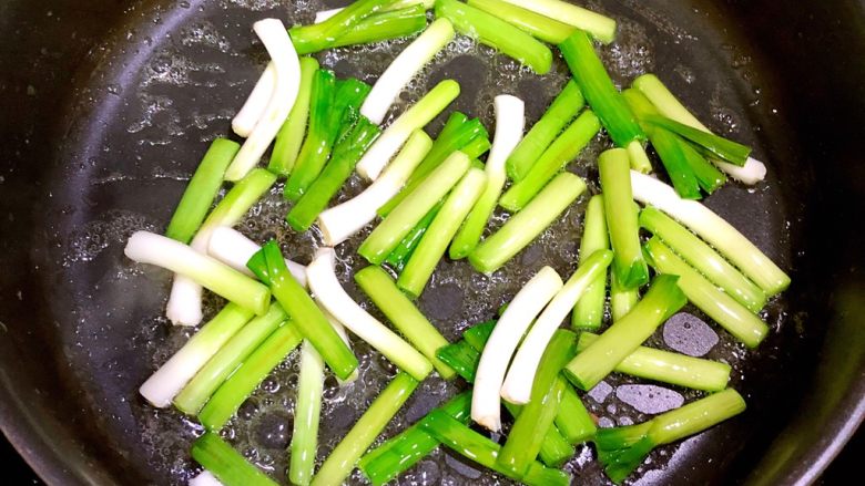 大蒜炒蛋,先放入蒜的根部,翻炒半分钟