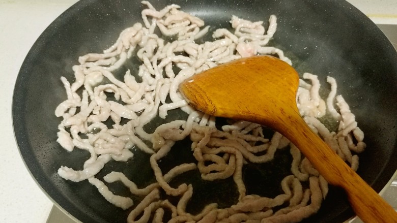 鱼香肉丝,快速翻炒,待肉丝发白时,盛出备用。
