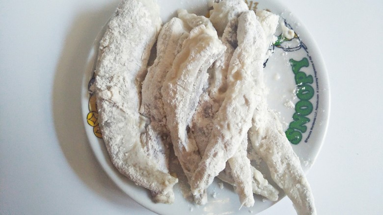 香酥龙头鱼,把龙头鱼一条一条裹上面粉,放盘子里备用