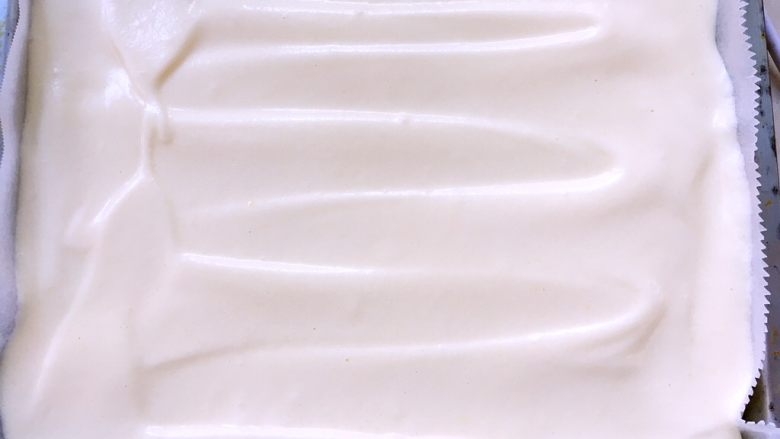 奶油盒子蛋糕,烤盘铺油纸,将搅拌好的面糊抬高倒入模具内,之后用刮刀将表明刮平正