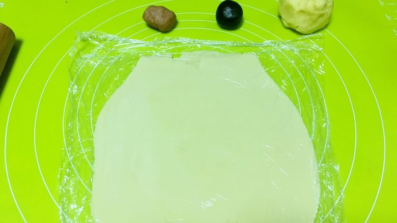 奶牛小饼干,取原色蛋白面团,盖保鲜膜擀成稍微厚一点的片