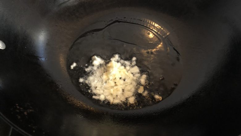 木耳香菜炒肉片,热锅凉油,下蒜末炒香。