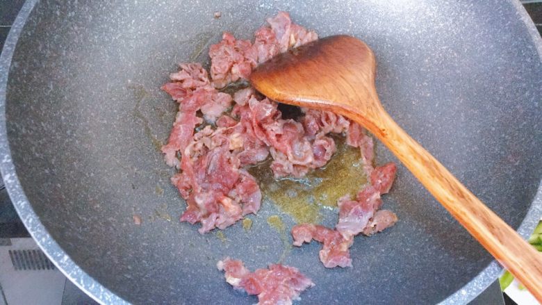 甜椒洋葱杏鲍菇炒牛肉,锅中倒入油,放入腌制好的牛肉,大火翻炒几下