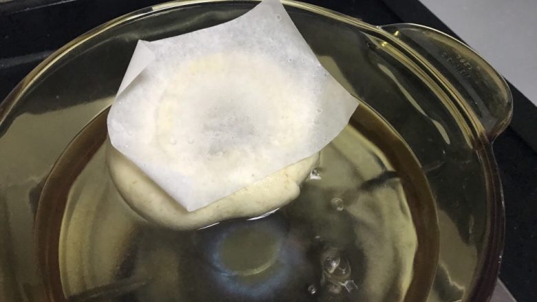 全麦贝果,发酵好的贝果连同烘焙纸正面朝下扔进锅里,约煮20-30秒。