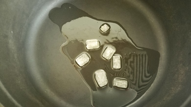 春笋焖肉,铸铁锅中放油,开至小火,加入冰糖慢慢融化。