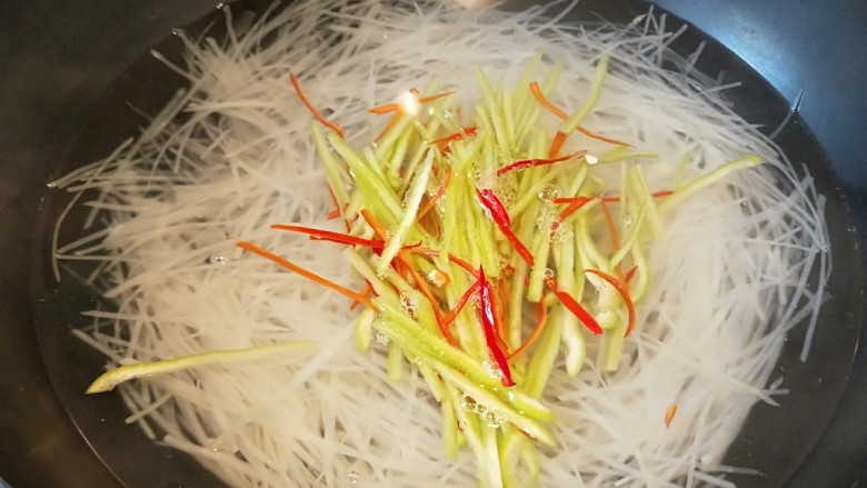 凉拌土豆丝,加适量辣椒丝马上捞出放入冷水中过凉,在放入盆中。