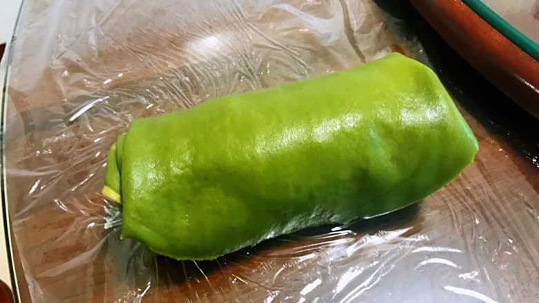 抹茶草莓毛巾卷,卷好如图,裹上保鲜膜放入冰箱冷藏2小时,定型