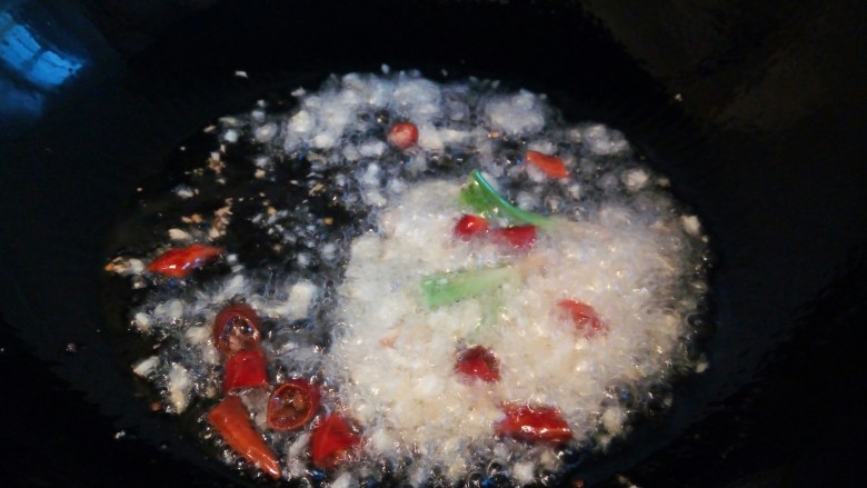 下酒菜【酱爆螺蛳】,锅里多放一点油,油温微微有点热时,加蒜,干辣椒,香菜梗,郫县豆瓣酱炒出香味