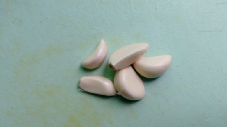 豆角焖面(简易版),蒜头剥好,用刀拍扁