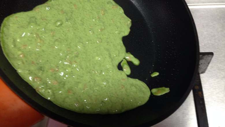 艾草火腿鸡蛋饼,用勺子舀适量面糊倒入锅中,迅速旋转锅体,让面糊尽量薄厚均匀的布满锅底,呈圆饼状(要用中下火)