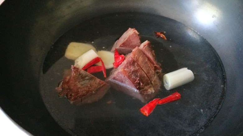麻油芝麻驴肉火烧,放入锅中,加葱姜蒜,辣椒在回锅煮半小时。