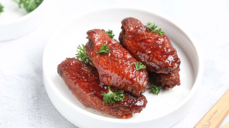 红腐乳烧鸡翅,出锅装盘,撒上些许<a style='color:red;display:inline-block;' href='/shicai/ 2784'>欧芹</a>碎。诱人的红腐乳烧鸡翅就做好了,是不是特别诱人呢?!