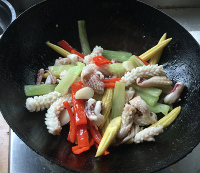玉米笋炒鲜鱿,倒入调味汁,翻炒入味