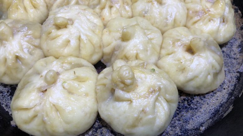 豆角猪肉生煎包,盖上锅盖煎熟,淀粉水水蒸发到差不多图片中状态时,就可以关火了。