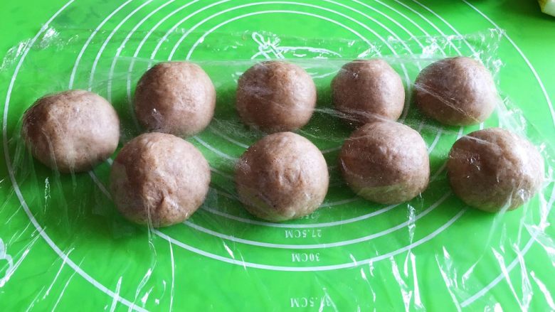 芝麻核桃三角包,将面团分成60克的剂子9个,盖上保鲜膜静置20分钟。