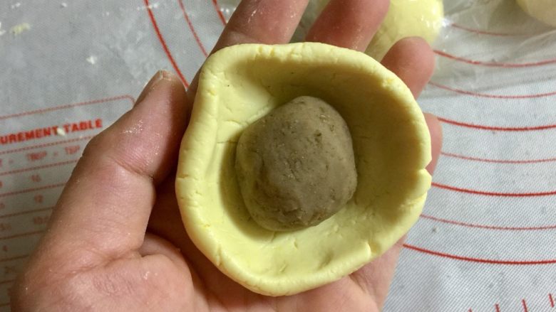 Q萌的栗子南瓜饼,把糯米团在手里按一下,转着边缘捏出碗状,把栗子馅团包进去。