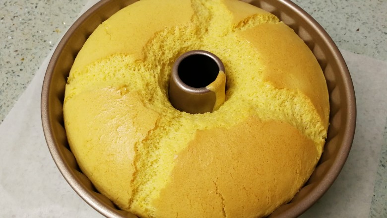 藜麦咕咕霍夫蛋糕(6寸),烤好出炉,轻震两下模具。完美的中空圆模蛋糕,表面应该会出现十字对称型裂口。说明搅拌手法、蛋白霜的打发和烘烤温度时间都配合得刚刚好。