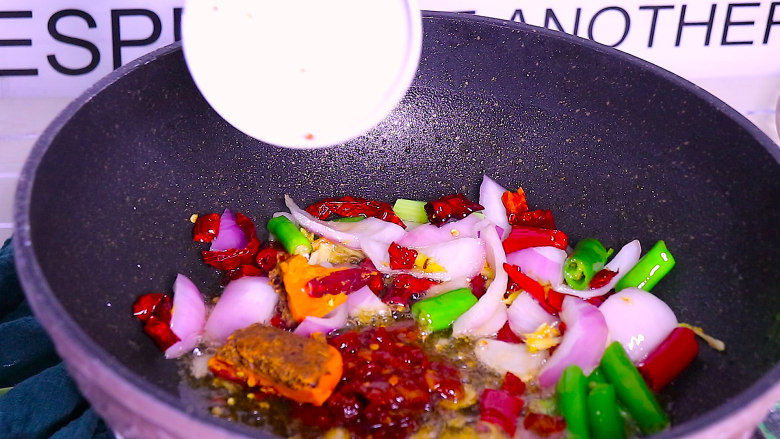 香辣干锅虾这样做秒杀饭店,再加入一勺豆瓣酱和一小块火锅底料,炒至火锅底料化开,炒出红油
