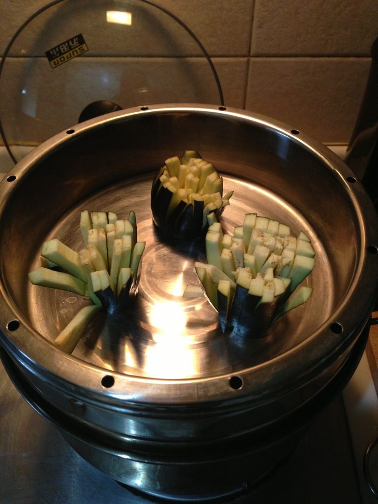 菊花茄子,锅内水开,将茄子上屉,蒸五分钟即可。