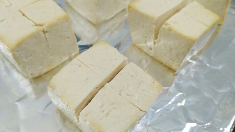 豆腐新花样,你不确定来一份吗?,然后拿菜刀出来切十字花刀,切深一点但不要切断。