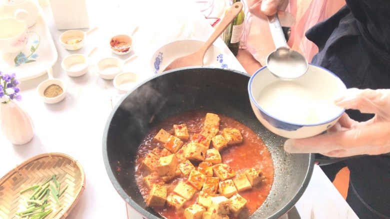 麻婆豆腐,沸腾后,分三次加入水淀粉勾芡。
第一次勾芡给豆腐增味