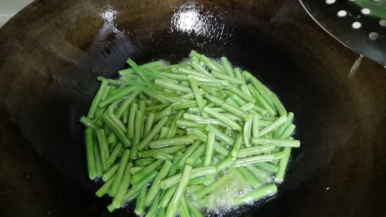 豆角茄条,油热以后加入豆角,加入一勺盐
