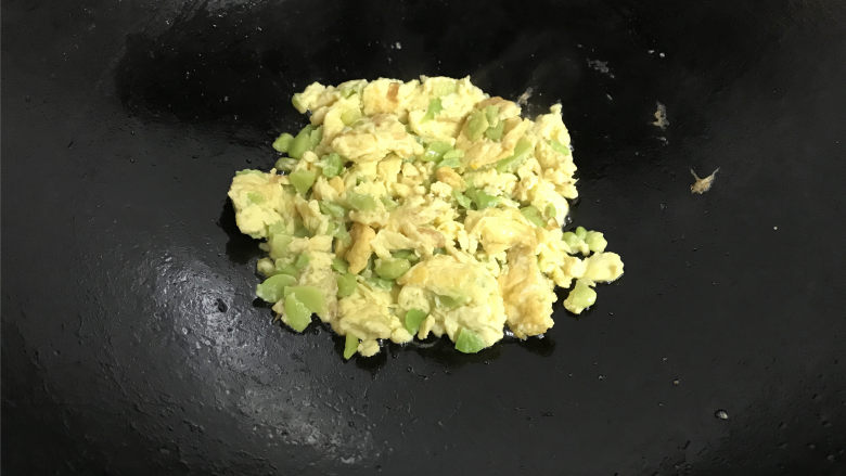 蚕豆炒鸡蛋,等蛋液稍凝固,用勺子将蛋液翻面后快速划散炒匀,再翻炒下即可出锅。