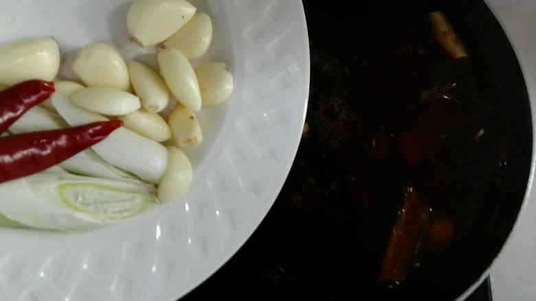 一碗幸福的红烧牛肉面,倒入葱蒜,辣椒。