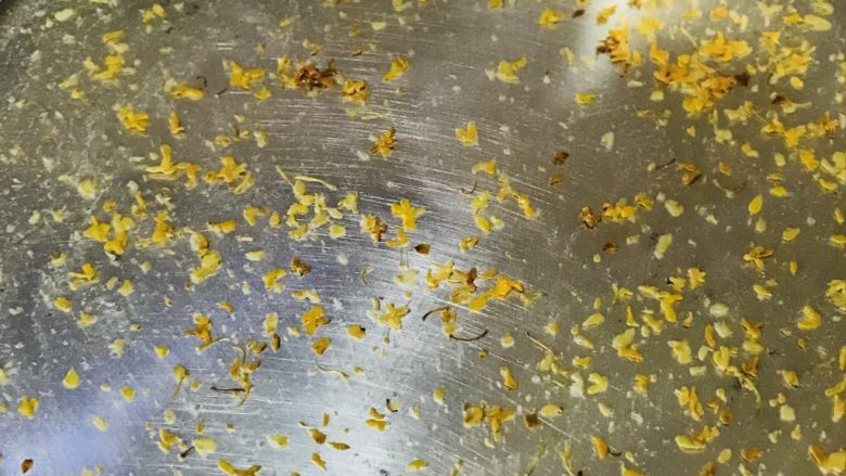 椰汁桂花糕,将煮好的桂花先放一层到盘中(可以用保鲜盒更好,透明可以看见每层多厚),然后放入冰箱冷冻层,对,就是急冻层,这样凝固更快一些
