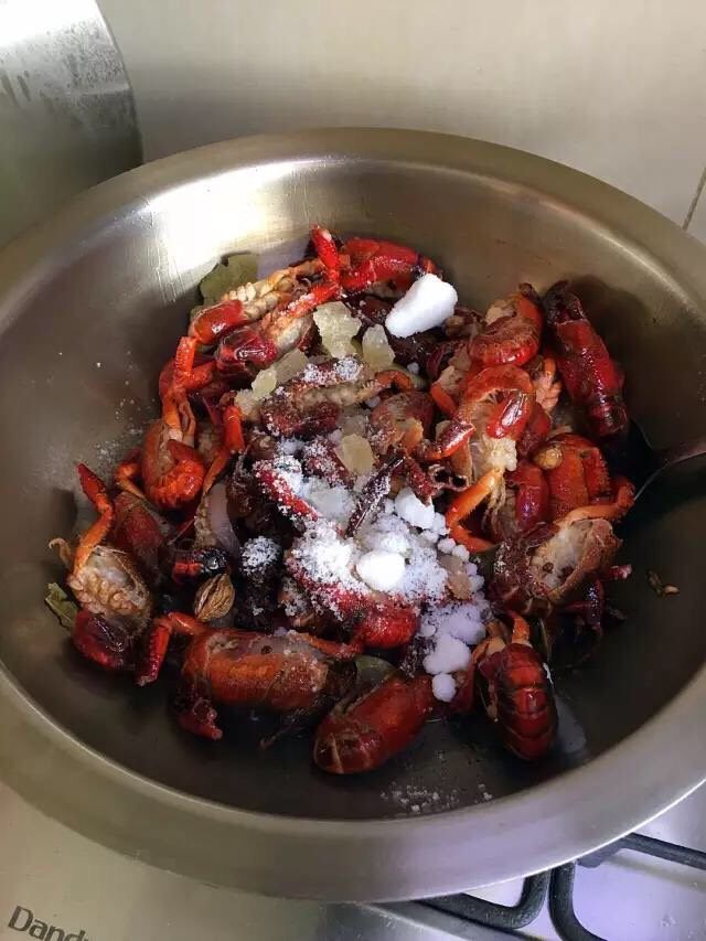 啤酒麻辣小龙虾,整体炸出香味后放进处理好的小龙虾进去翻炒。待龙虾全部炒变色,并且尾部向里卷起,将白糖、冰糖一起倒进去翻炒均匀。